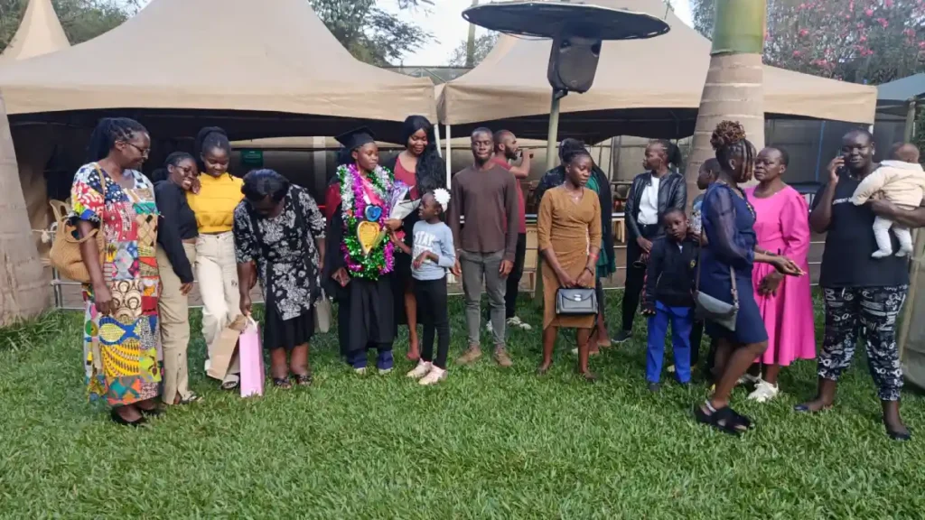 A DestinyImpact CBO representative with a beneficiary celebrating their graduation with a bachelor’s degree in Bungoma, Kenya.