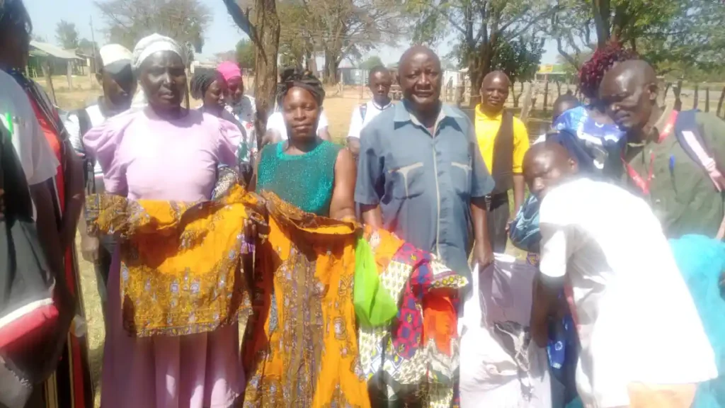 DestinyImpact CBO team with Kenya Red Cross members during a joint clothing donation drive in Bungoma County, distributing clothes to vulnerable families.