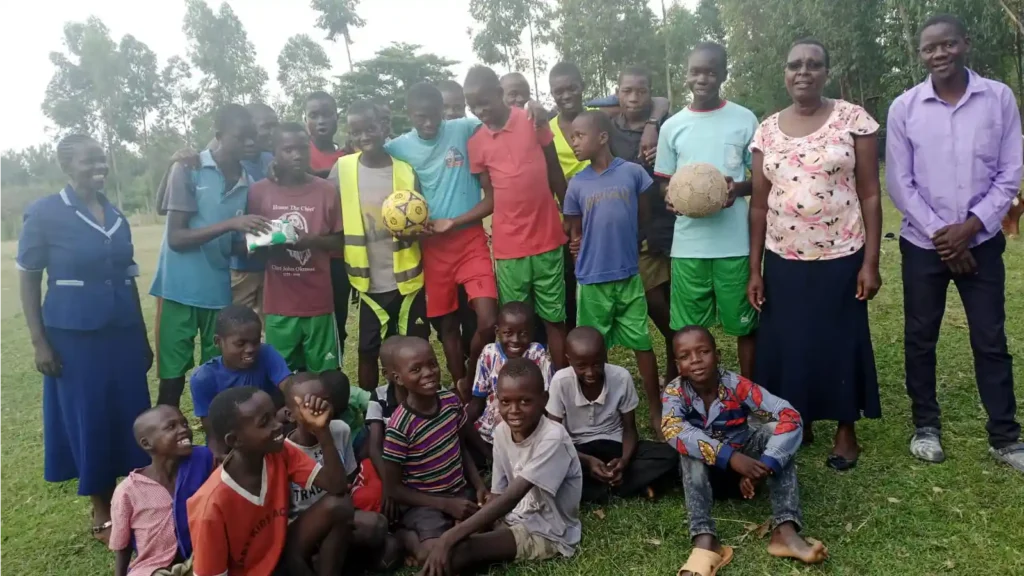 Older members of the DestinyImpact youth sports club in Wacholi, Bungoma County, engaging in teamwork and leadership through sports.