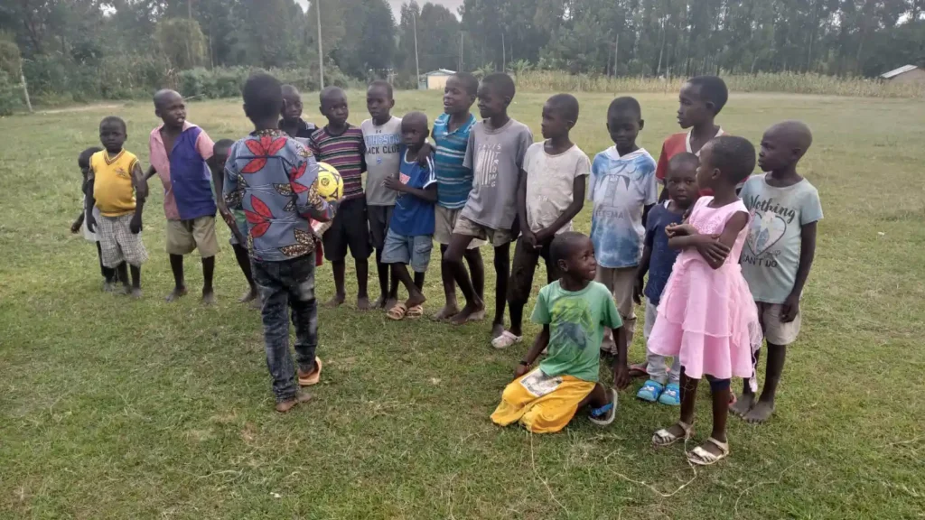 Young members of the DestinyImpact youth sports club in Wacholi, Bungoma County, playing and building teamwork through community sports.