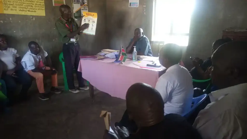 Destiny Impact team conducting a health awareness session at the Mayanja Chief’s Office along the Bungoma–Malaba Highway, educating community members on outbreaks such as Ebola, cholera, malaria, and COVID-19.