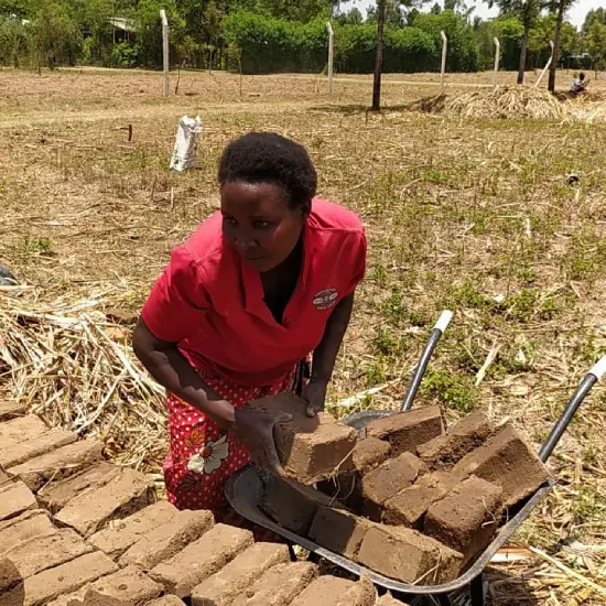 Molding clay bricks as part of a Destiny Impact community empowerment project.