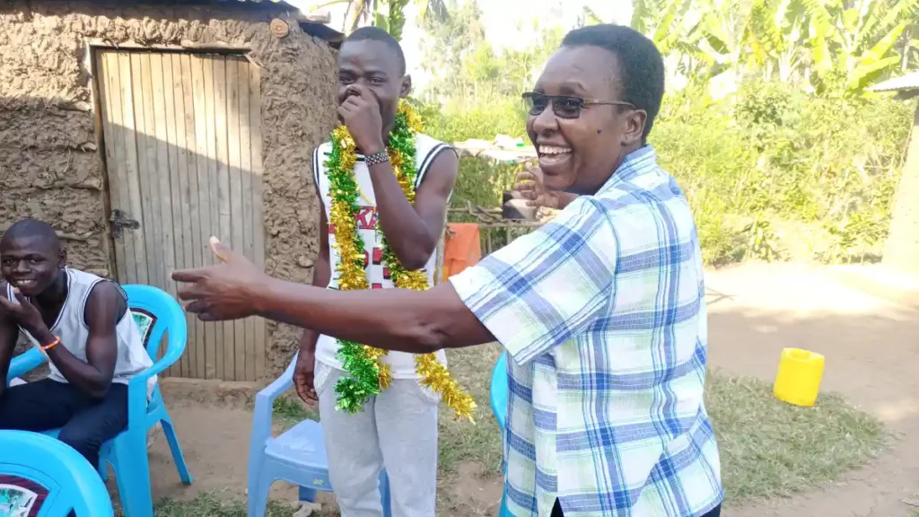 Destiny Impact team and Michael’s family celebrating his successful completion of high school and national exam results.