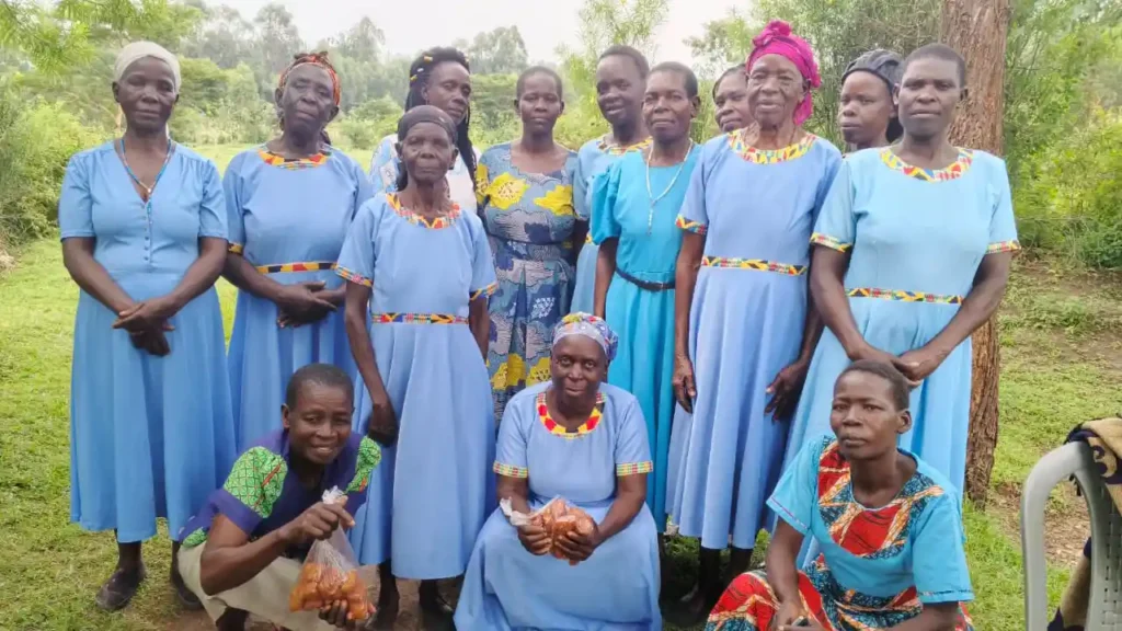 Members of the Wacholi Women’s Group standing beside the donated cow during a handover ceremony with the local MCA.
