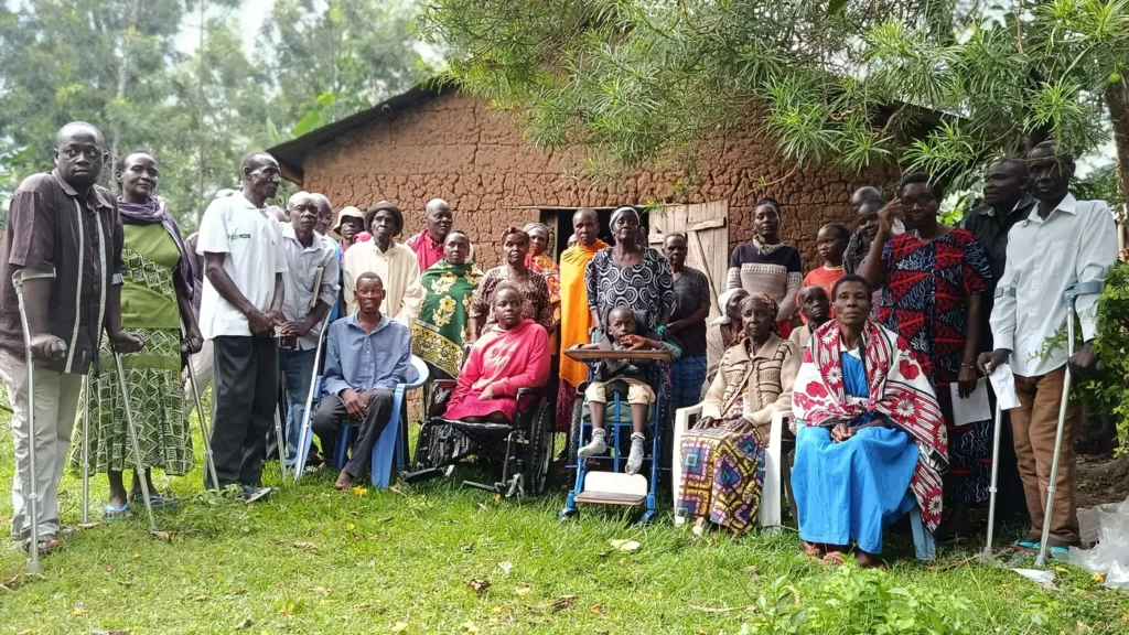 Persons with disabilities and their families at Ng'oli, Bungoma County after the handover of 15 crutches and two wheelchairs donated by NCPWD, 23 August 2025