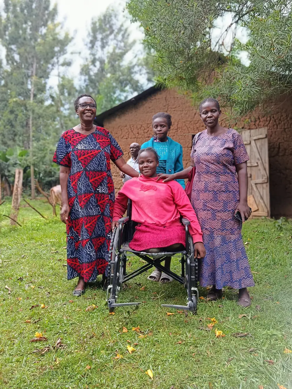 A young wheelchair user with two Destiny members at Ng'oli, Bungoma County
