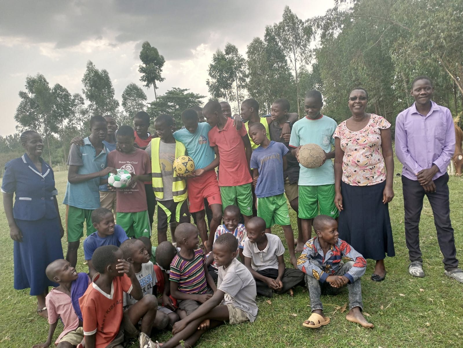 Young footballers in Wacholi holding their new footballs